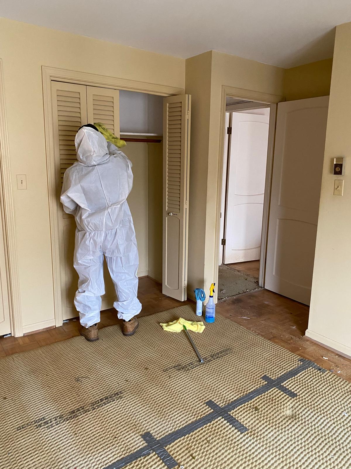 Evinco Services team member in protective equipment during hoarder cleanup