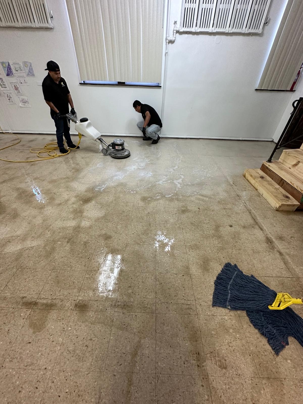 Evinco Services team stripping and buffing commercial floor with industrial equipment in Chicago suburbs